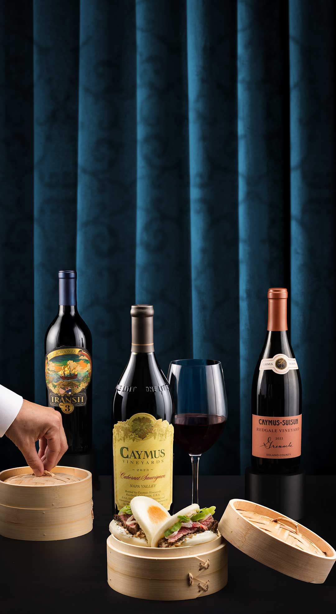 Bottles of Caymus wine served with two steak baos.